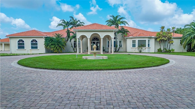 mediterranean / spanish-style house featuring a front yard