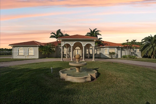 mediterranean / spanish-style home featuring a yard