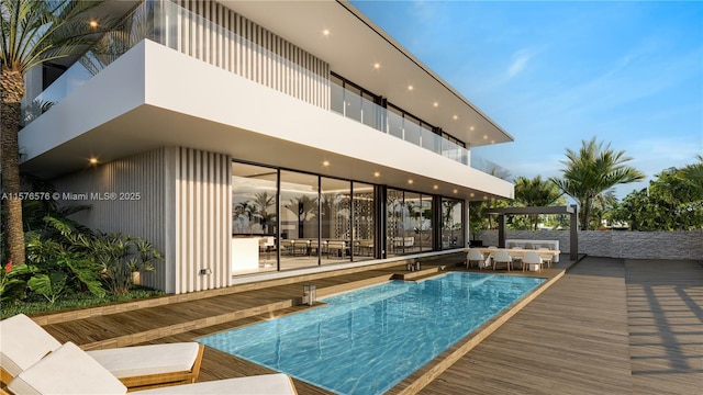 view of swimming pool with a wooden deck