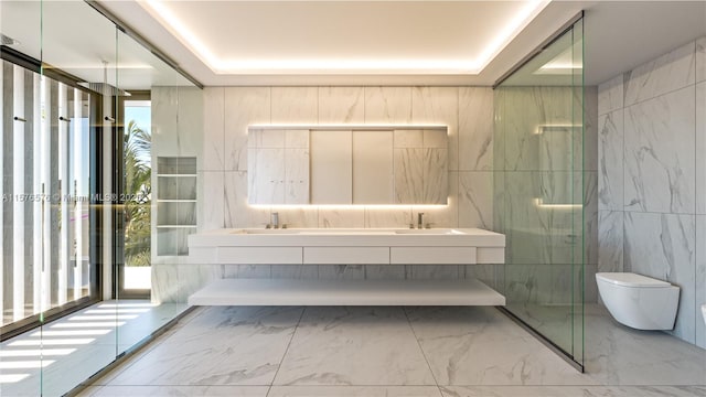 bathroom with vanity, toilet, a tray ceiling, and tile walls