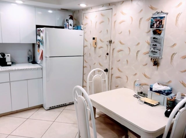 kitchen with light tile patterned flooring and white appliances