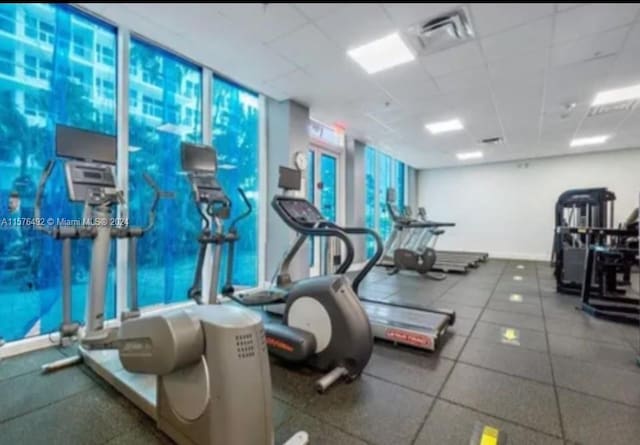 exercise room with a paneled ceiling