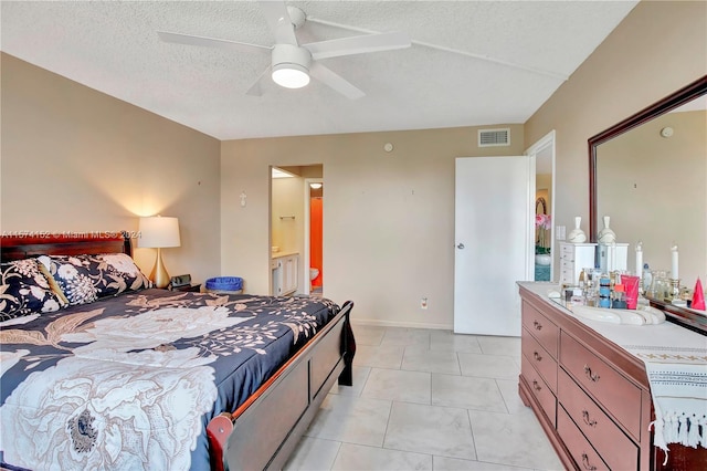 bedroom featuring sink, ceiling fan, light tile floors, and a textured ceiling