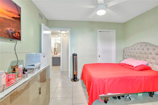 tiled bedroom featuring ceiling fan