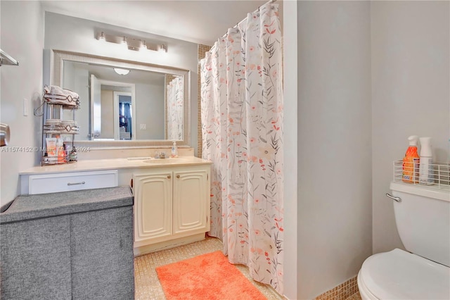 bathroom featuring large vanity and toilet