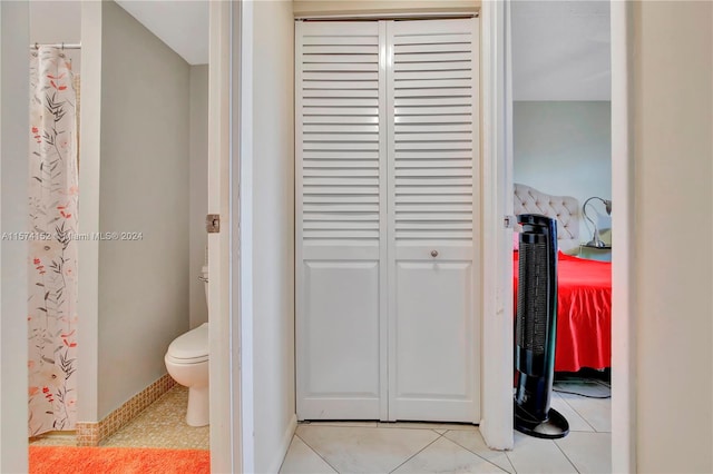 bathroom with tile flooring and toilet