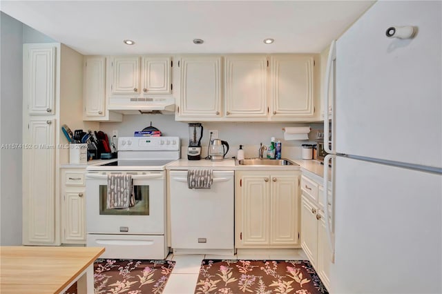 kitchen featuring premium range hood, sink, white appliances, and light tile flooring