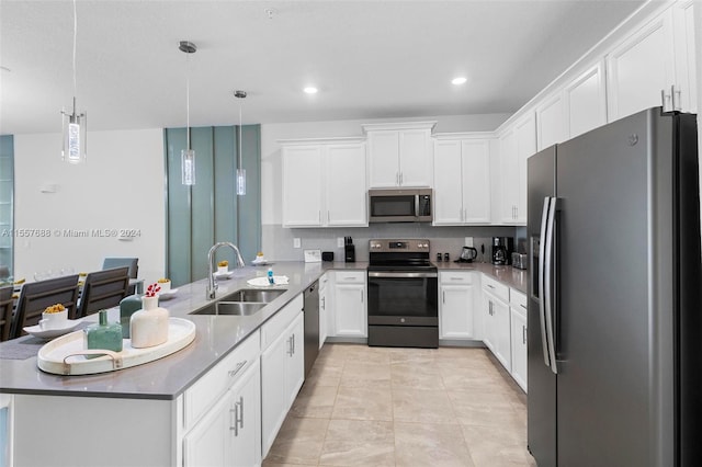 kitchen featuring kitchen peninsula, hanging light fixtures, stainless steel appliances, light tile flooring, and sink