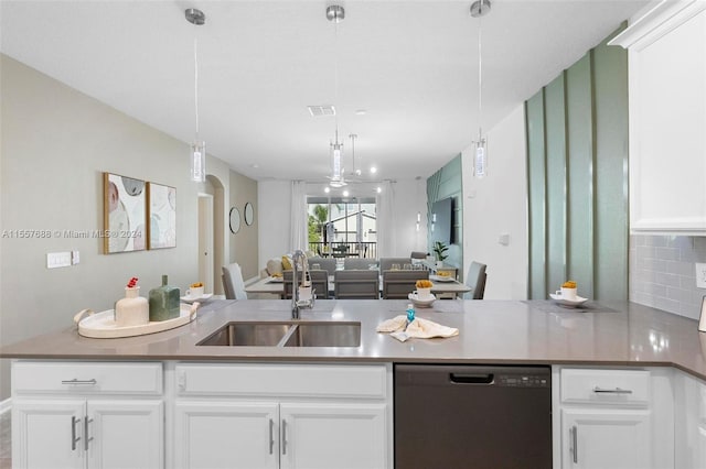 kitchen featuring white cabinets, sink, decorative light fixtures, and dishwashing machine