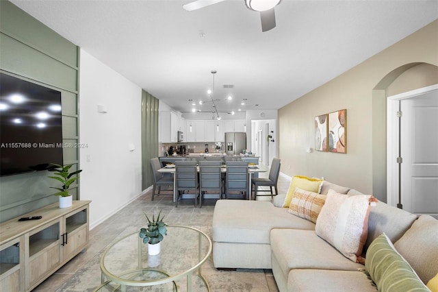 tiled living room featuring ceiling fan