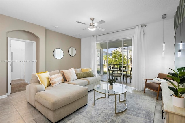 tiled living room featuring ceiling fan