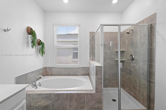 bathroom featuring vanity and separate shower and tub