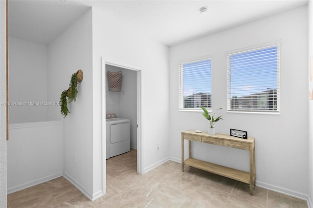 corridor featuring washer / dryer and light tile floors