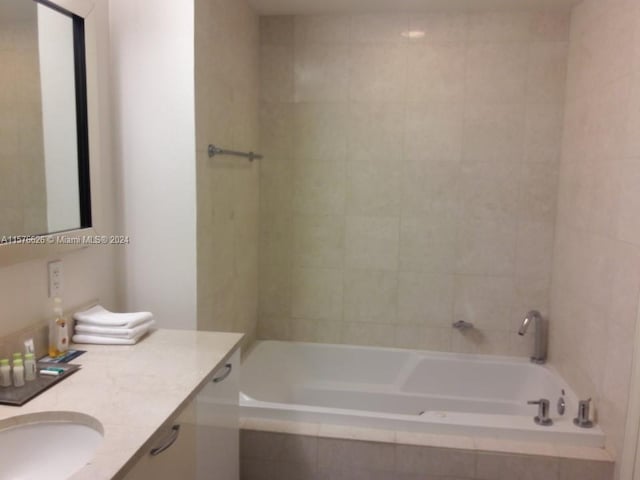 bathroom with vanity and tiled shower / bath