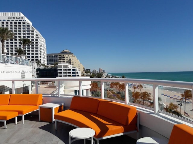 balcony featuring outdoor lounge area, a beach view, and a water view