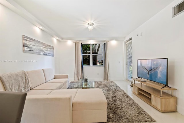 living room featuring plenty of natural light and light tile floors