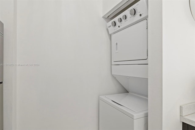 laundry room featuring stacked washer / drying machine