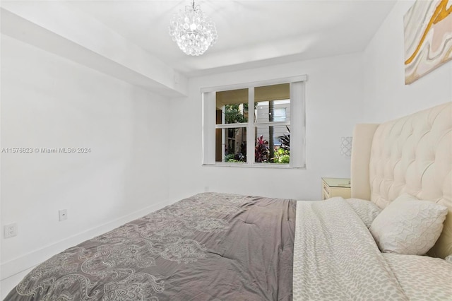 bedroom with an inviting chandelier