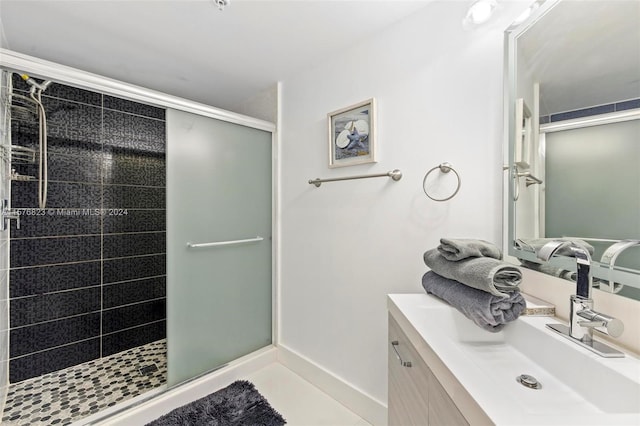 bathroom with a shower with shower door and vanity