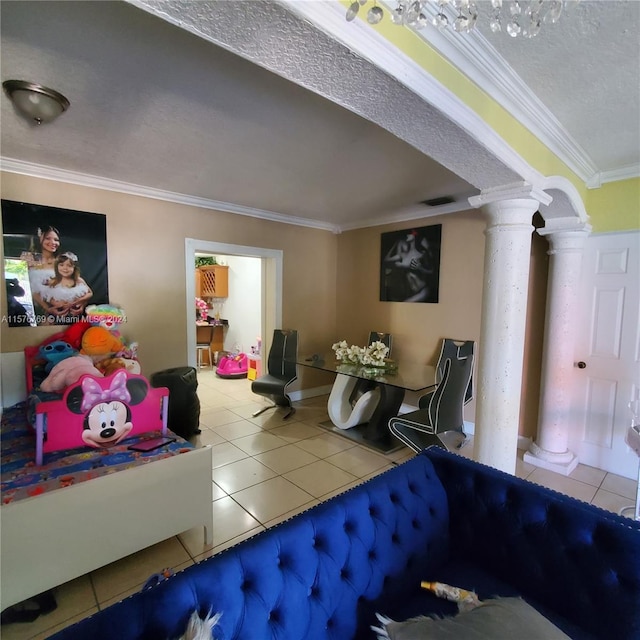 tiled living room with ornamental molding, a textured ceiling, and ornate columns