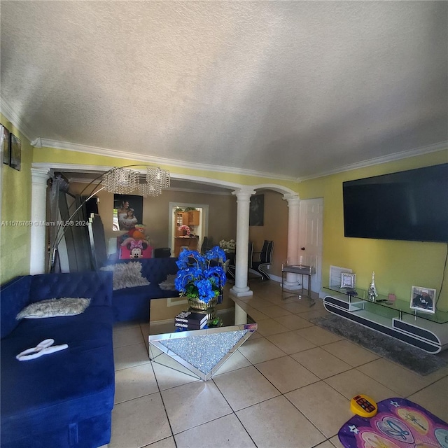 living room featuring ornate columns, tile floors, a textured ceiling, and crown molding