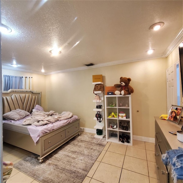 tiled bedroom featuring crown molding and a textured ceiling