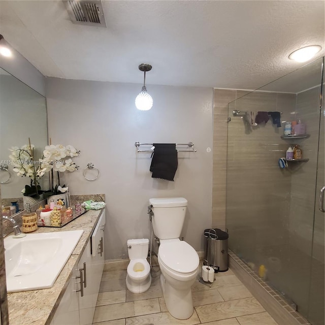 bathroom featuring tile flooring, an enclosed shower, toilet, and vanity