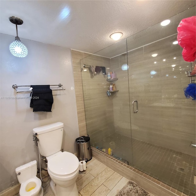 bathroom featuring walk in shower and toilet