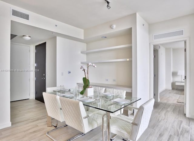 dining space featuring light wood-type flooring