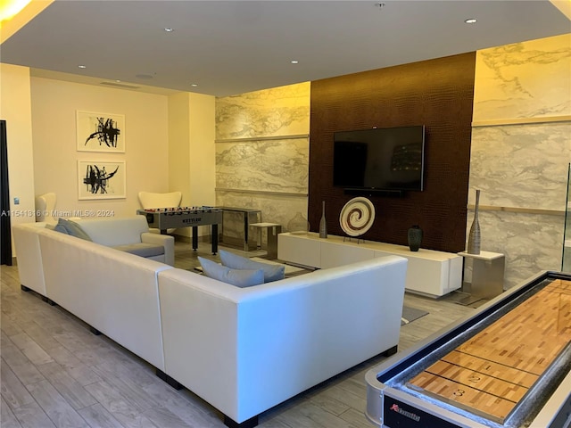 living room featuring tile walls and hardwood / wood-style floors