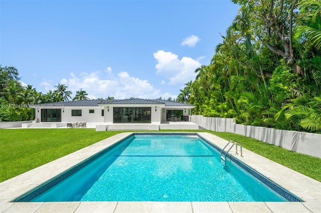 view of pool featuring a yard, a patio area, fence, and a fenced in pool