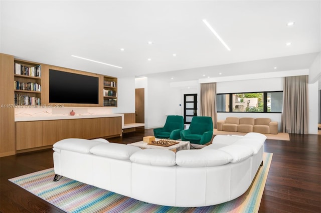 living room with dark wood finished floors and recessed lighting