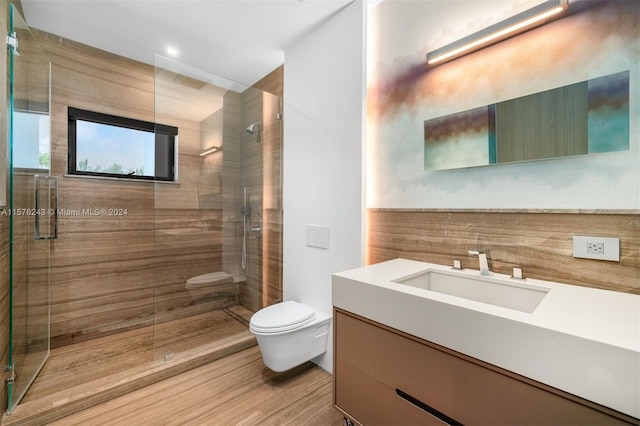 full bathroom with toilet, a shower stall, wood finished floors, and vanity