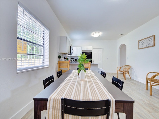 dining space with light wood-type flooring