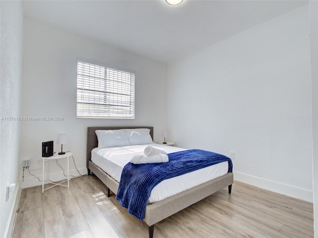 bedroom with light hardwood / wood-style floors