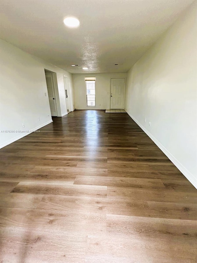 spare room featuring a textured ceiling and hardwood / wood-style flooring