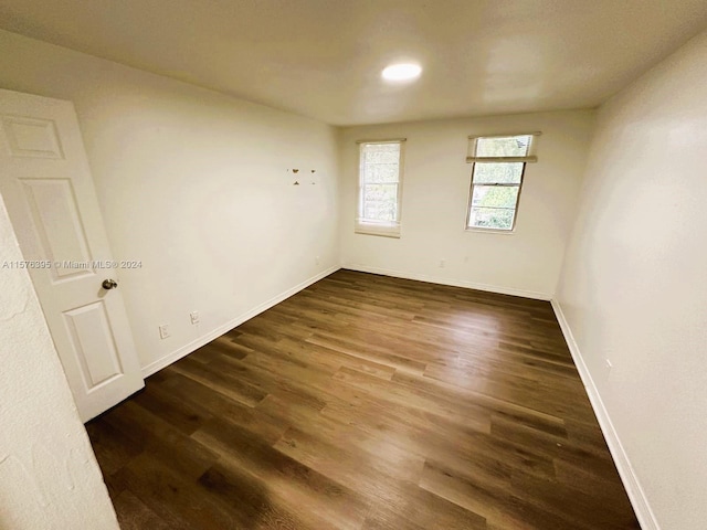 empty room featuring dark wood-type flooring