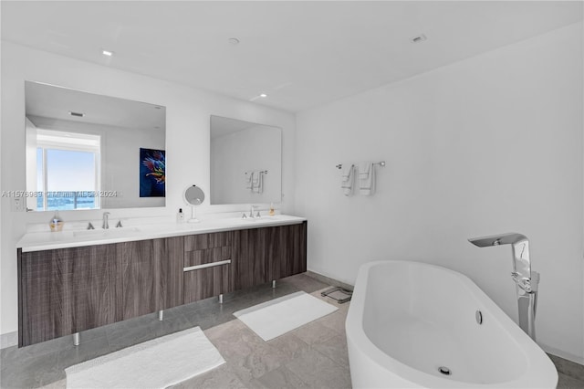 bathroom featuring a bath to relax in, double vanity, and tile floors