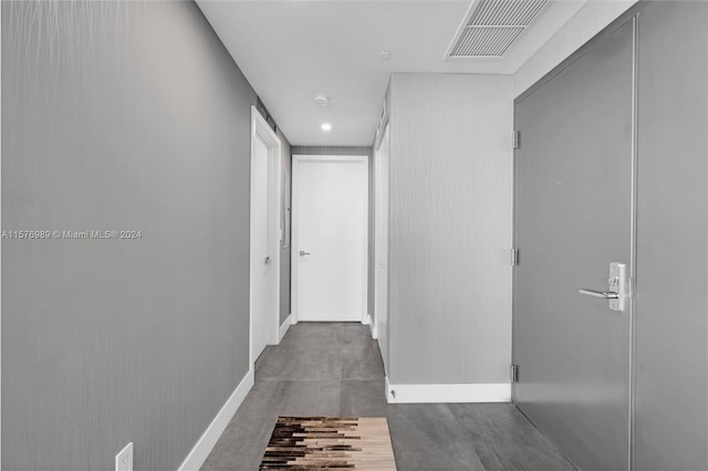 hallway with concrete flooring