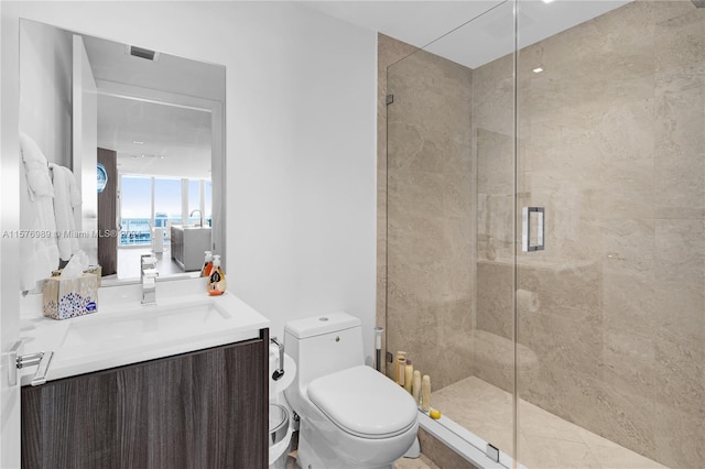 bathroom featuring walk in shower, vanity, and toilet