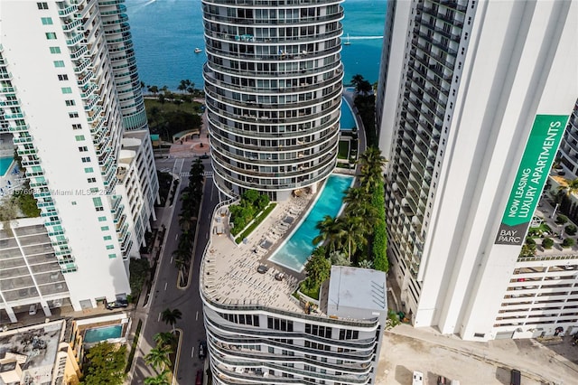 exterior space featuring a pool and a water view