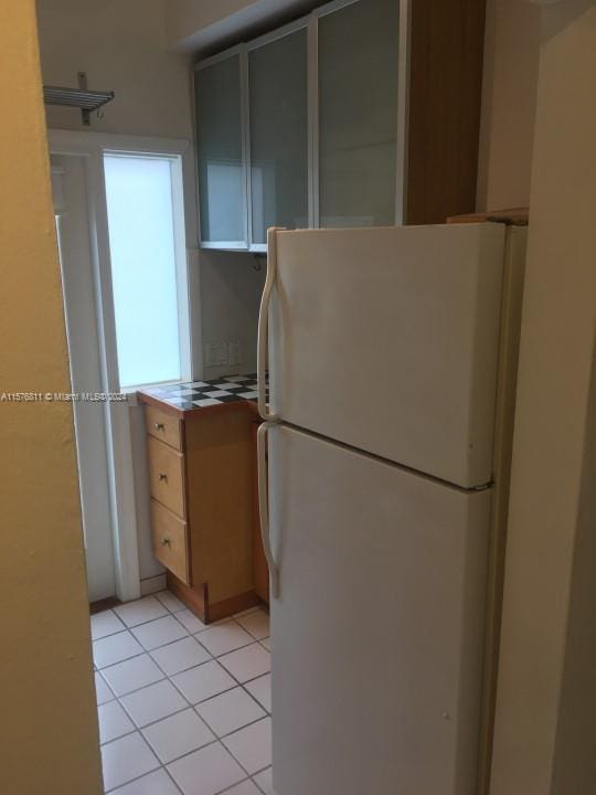 kitchen featuring white fridge and light tile patterned floors