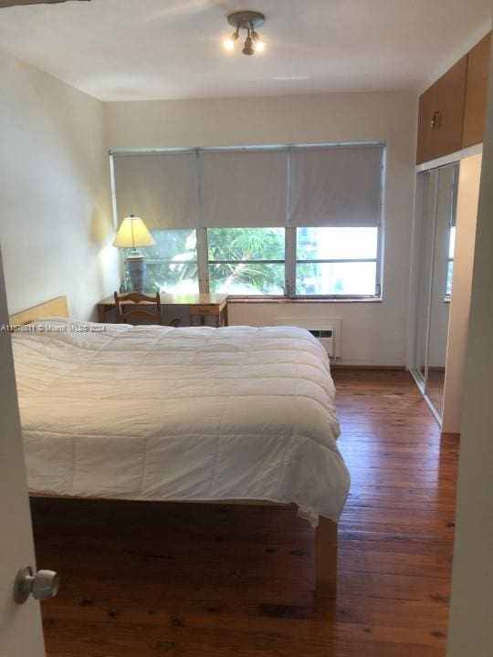 bedroom with hardwood / wood-style flooring