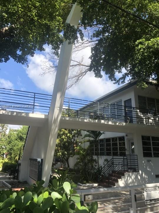 back of property featuring a balcony