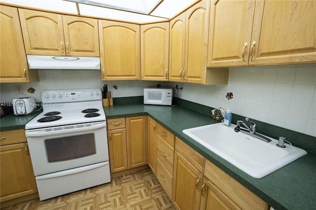 kitchen with backsplash, white appliances, light parquet flooring, and sink