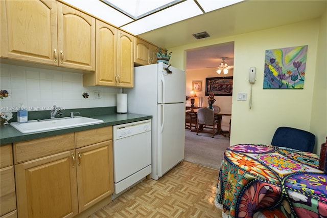 kitchen featuring light carpet, white appliances, backsplash, sink, and ceiling fan