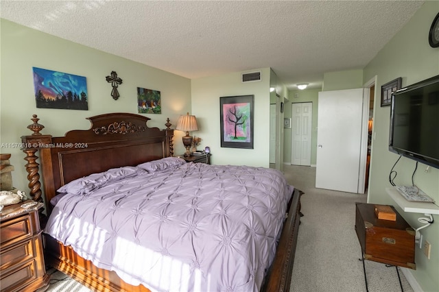 bedroom with carpet and a textured ceiling