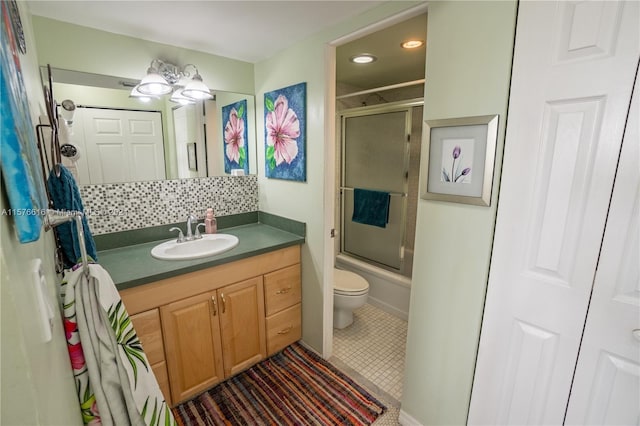 full bathroom with toilet, enclosed tub / shower combo, tasteful backsplash, vanity, and tile floors