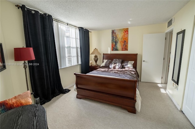 carpeted bedroom featuring a textured ceiling