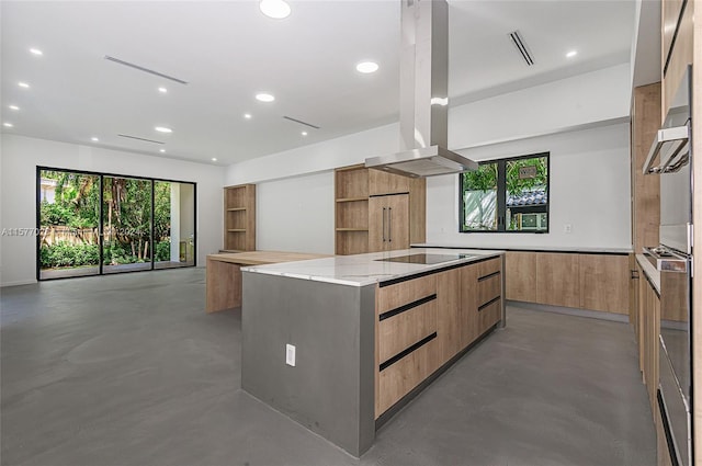 kitchen featuring appliances with stainless steel finishes, concrete floors, island range hood, and light stone counters